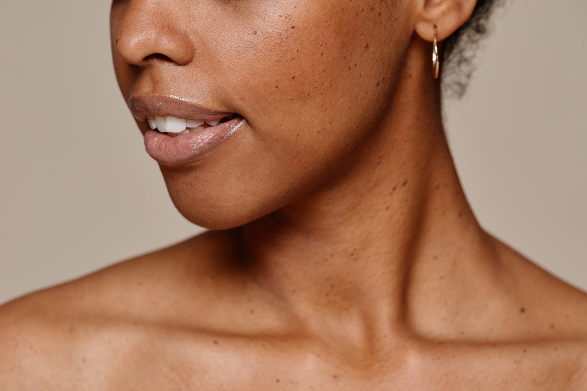 A woman with her hair up showing her shoulder and neckline